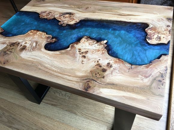 an occasional burry elm river table with deep blue resin.