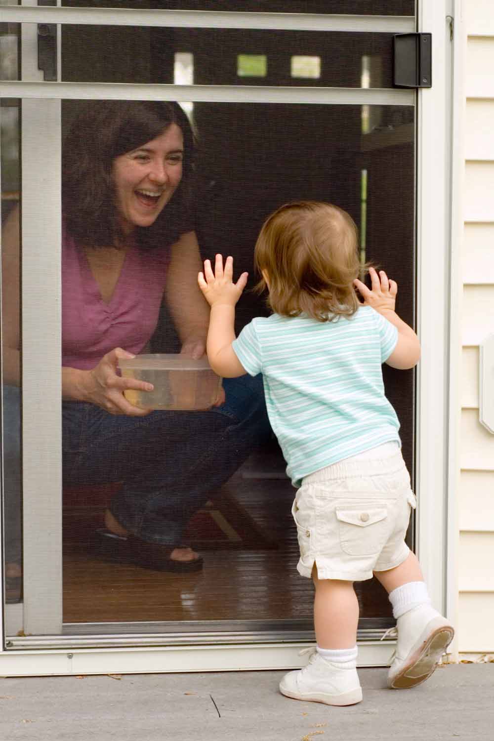 Mother and child at screen door