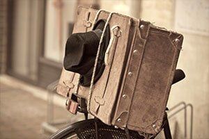 Shabby Black Hat and Brown Suitcase -  Luggage Repair in Philadelphia, PA