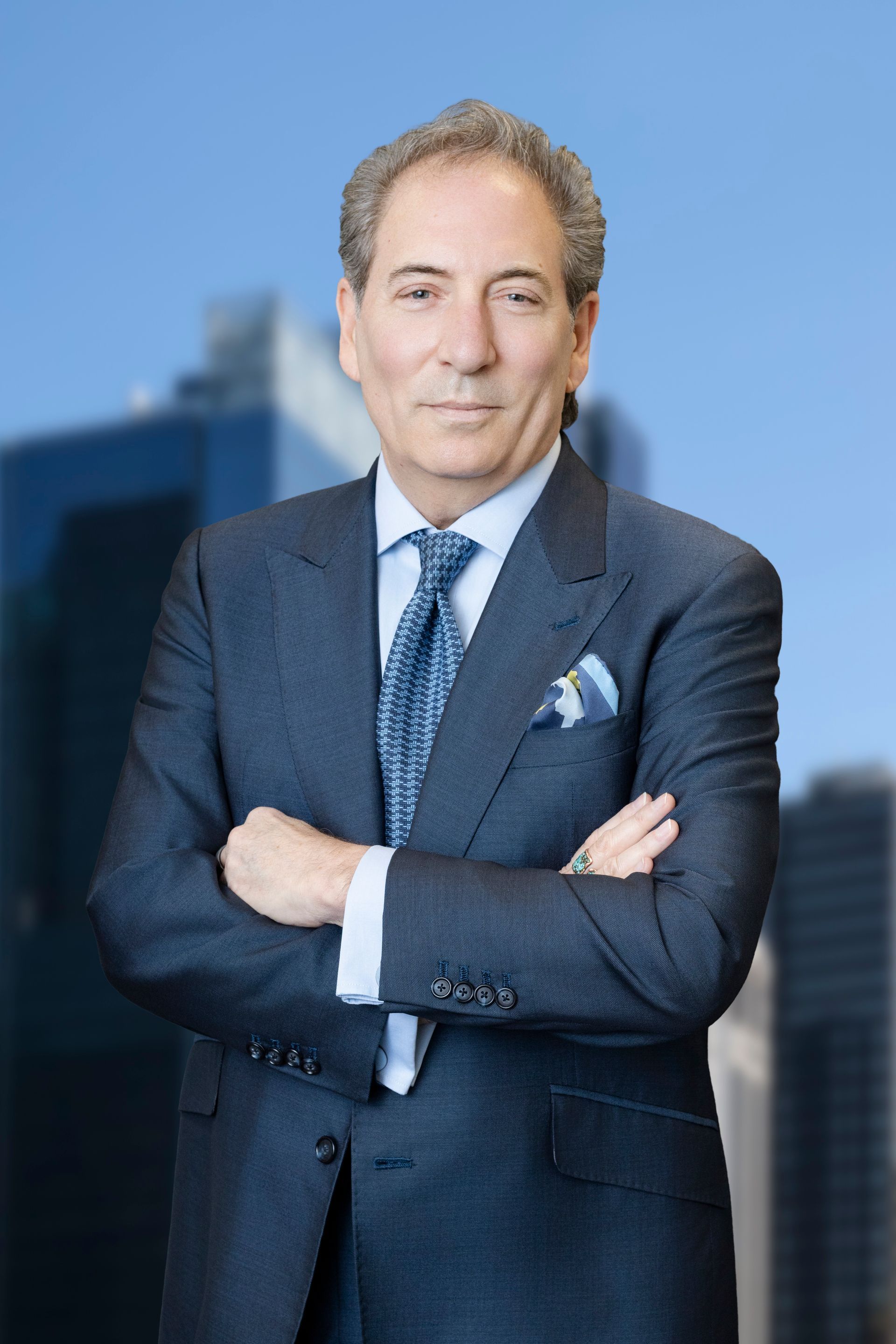 A man in a suit and tie is smiling for the camera