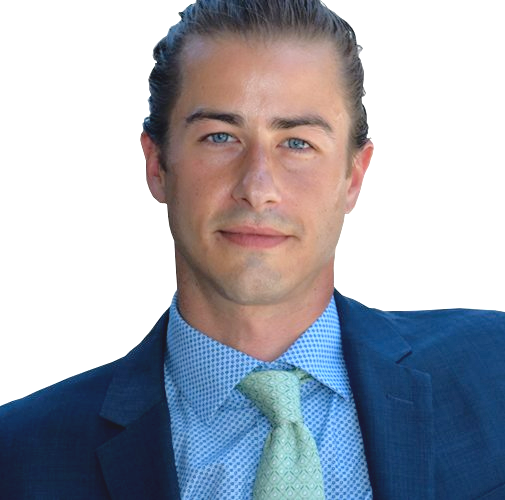 A man in a suit and tie looks at the camera
