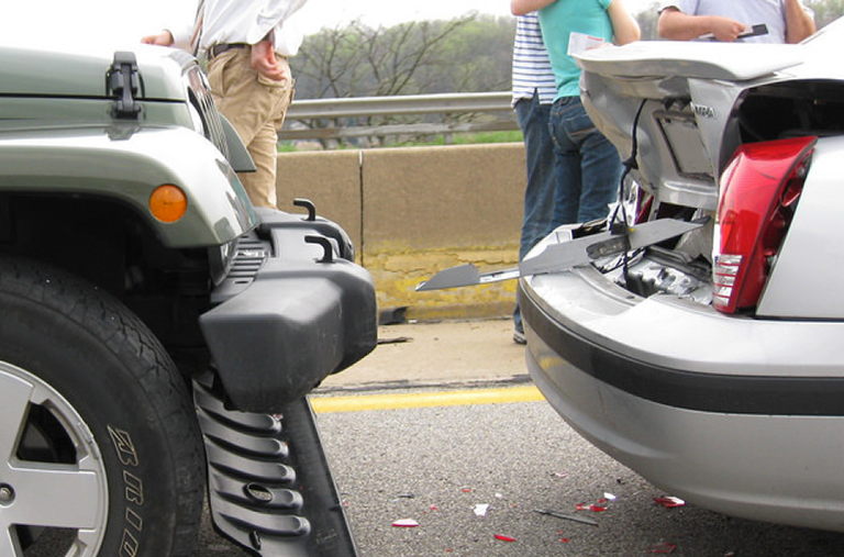 A jeep and a car are involved in an accident on the highway