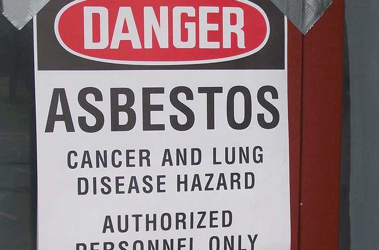 A sign that says danger asbestos cancer and lung disease hazard