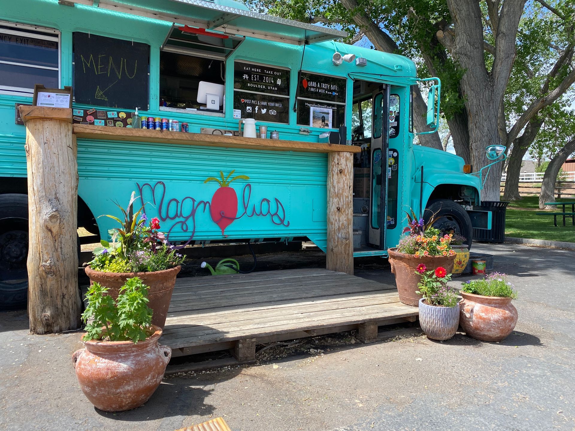 A bunch of green vegetables are sitting on a wooden table.