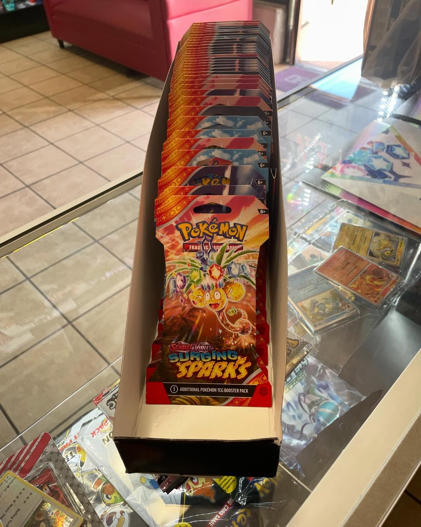 A box of pokemon cards is sitting on a table.