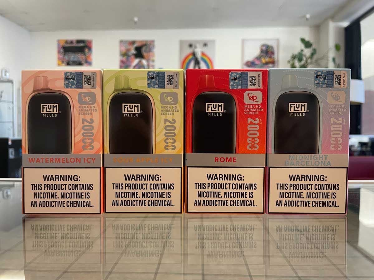 A row of electronic cigarettes are lined up on a table.