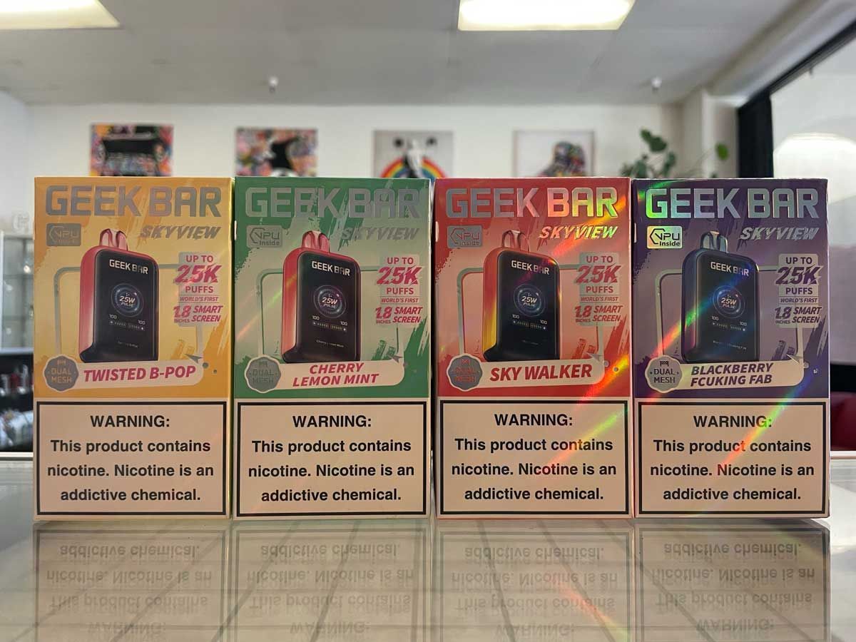 A row of geek bar boxes are lined up on a table.