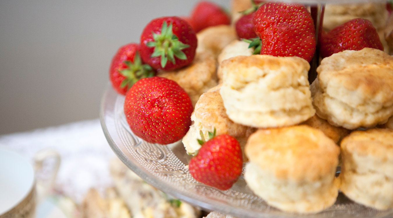 A tray of freshly baked scones with strawberries