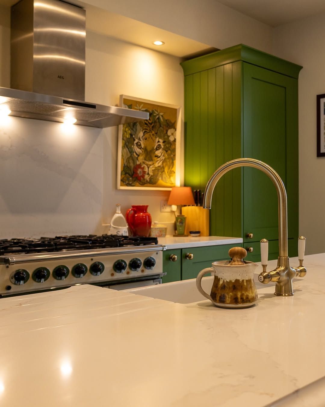 Luxury statement kitchen designed by James James Kitchens, featuring bold green cupboards