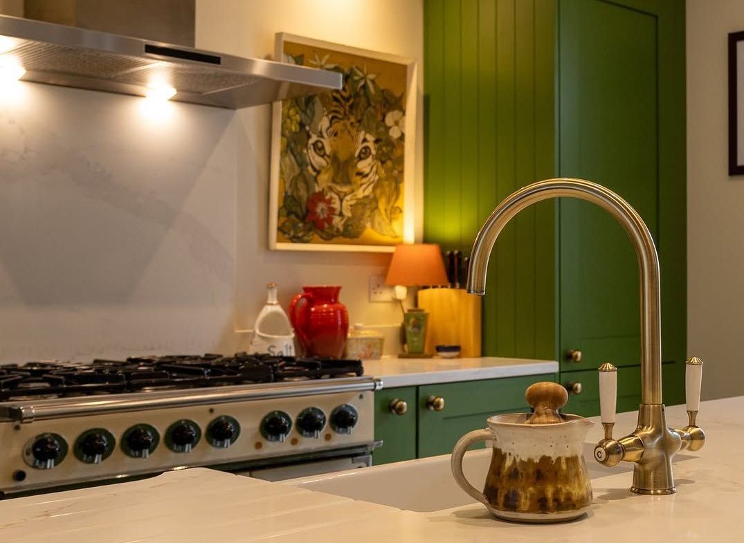 Luxury gold feature tap with bold green cupboards designed by James James Kitchens Luxury gold feature tap with bold green cupboards designed by James James Kitchens