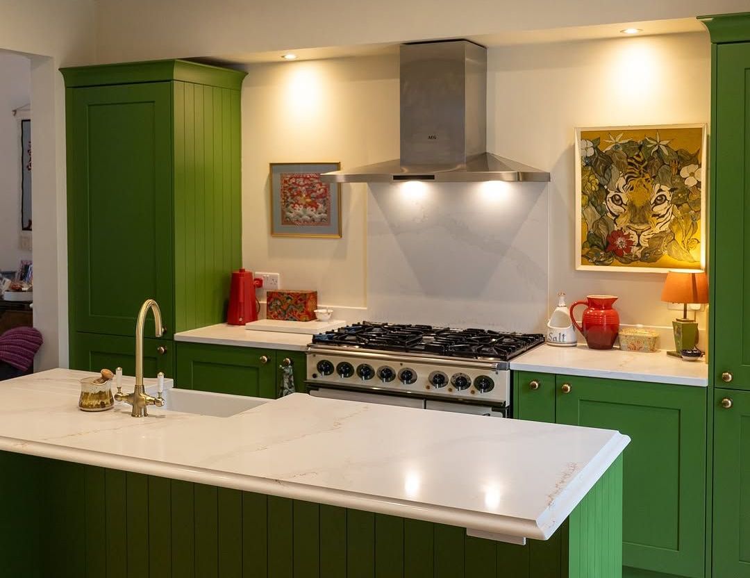 A luxury, bold green statement kitchen with bright counter tops designed by James James Kitchens in West Kirby