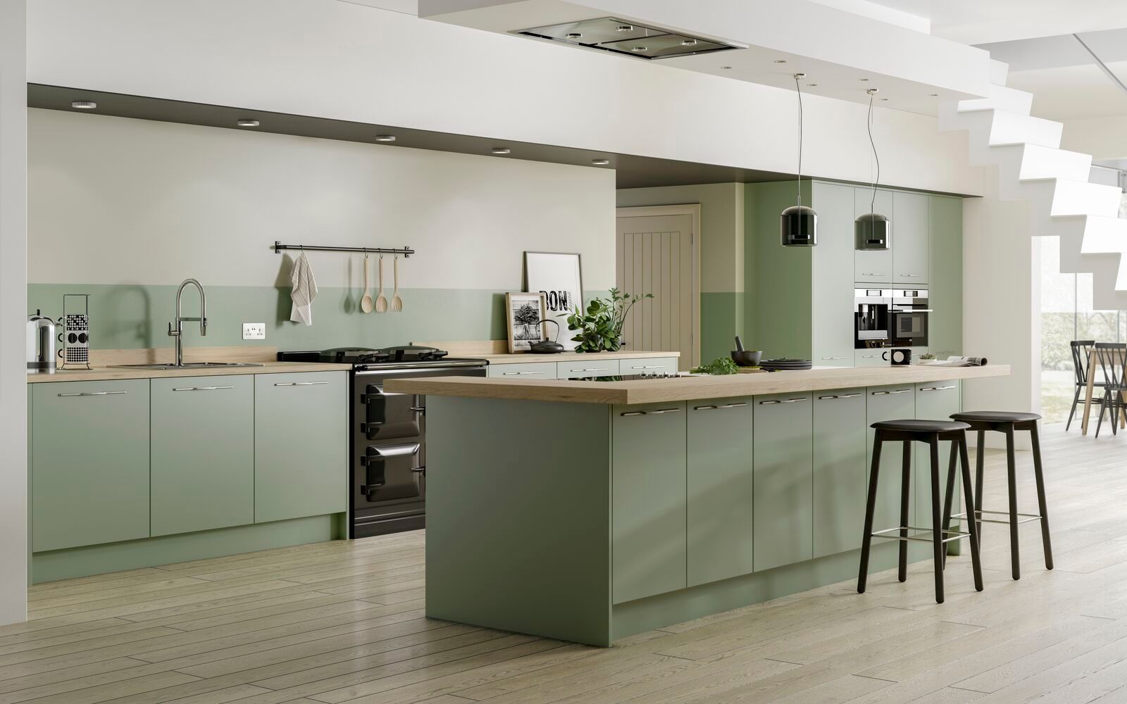 A kitchen with green cabinets and a large island in the middle.