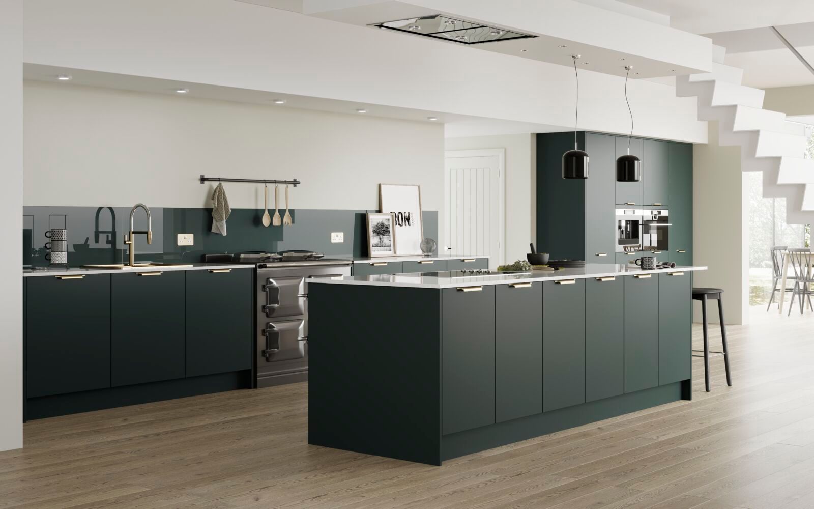 A kitchen with green cabinets and a large island in the middle