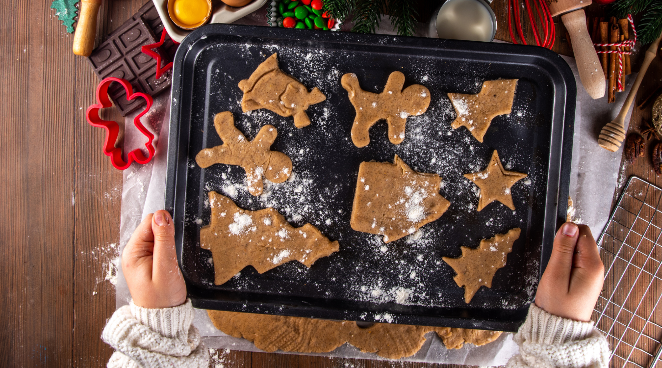 Someone holiday a tray of baked Christmas cookies surrounded by festive decoration Someone holiday a tray of baked Christmas cookies