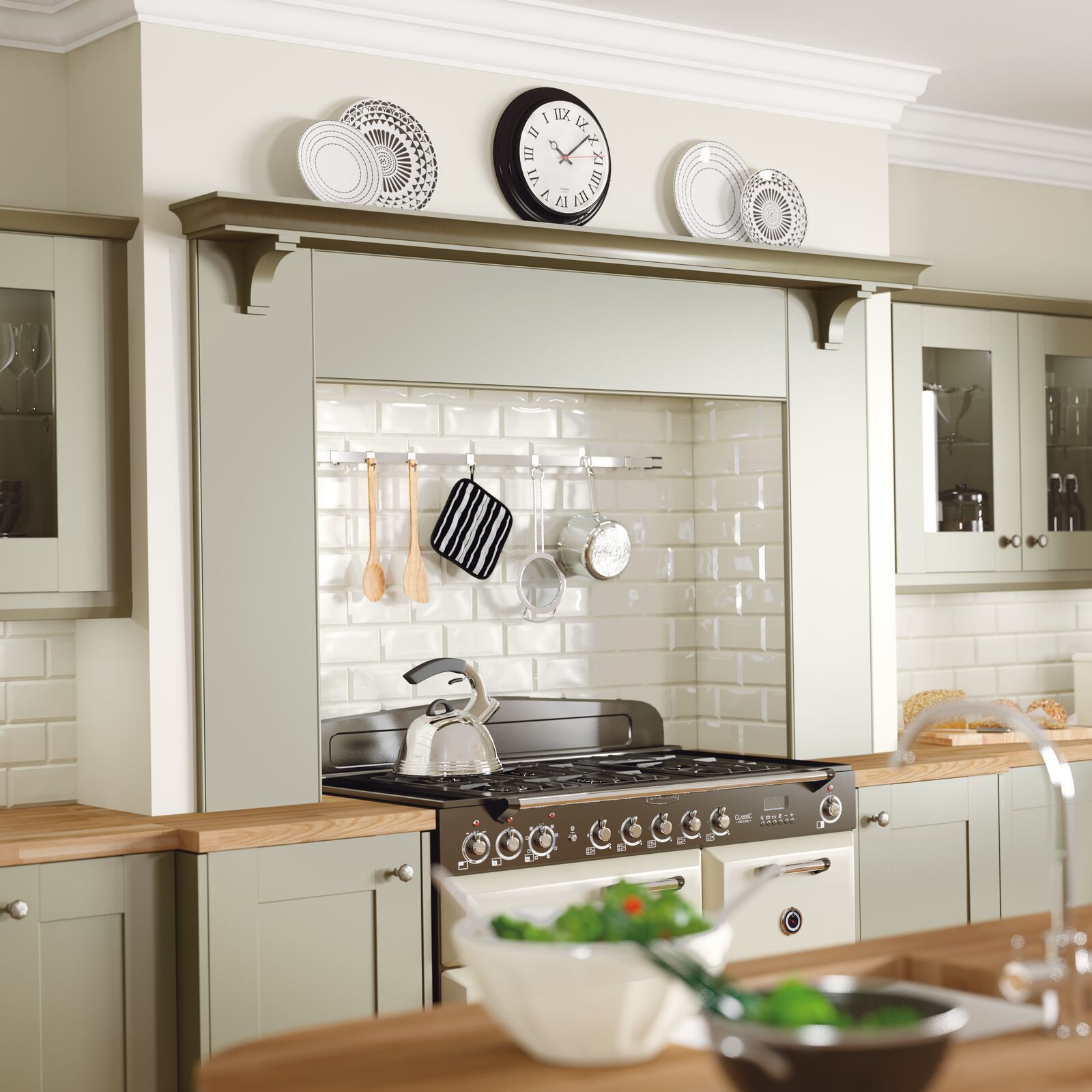 A kitchen with a clock on the wall above the stove