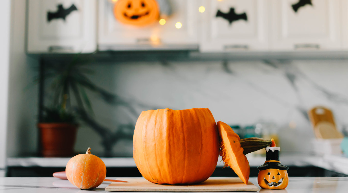 Halloween pumpkins sitting on a kitchen counter top