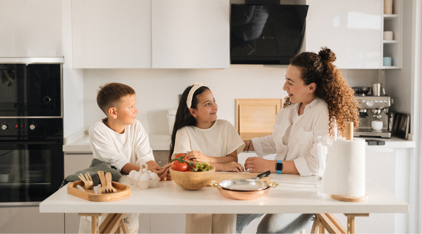 Family gathering around an island in a luxury kitchen Tips to design a luxury kitchen that is child friendly by James James Kitchens