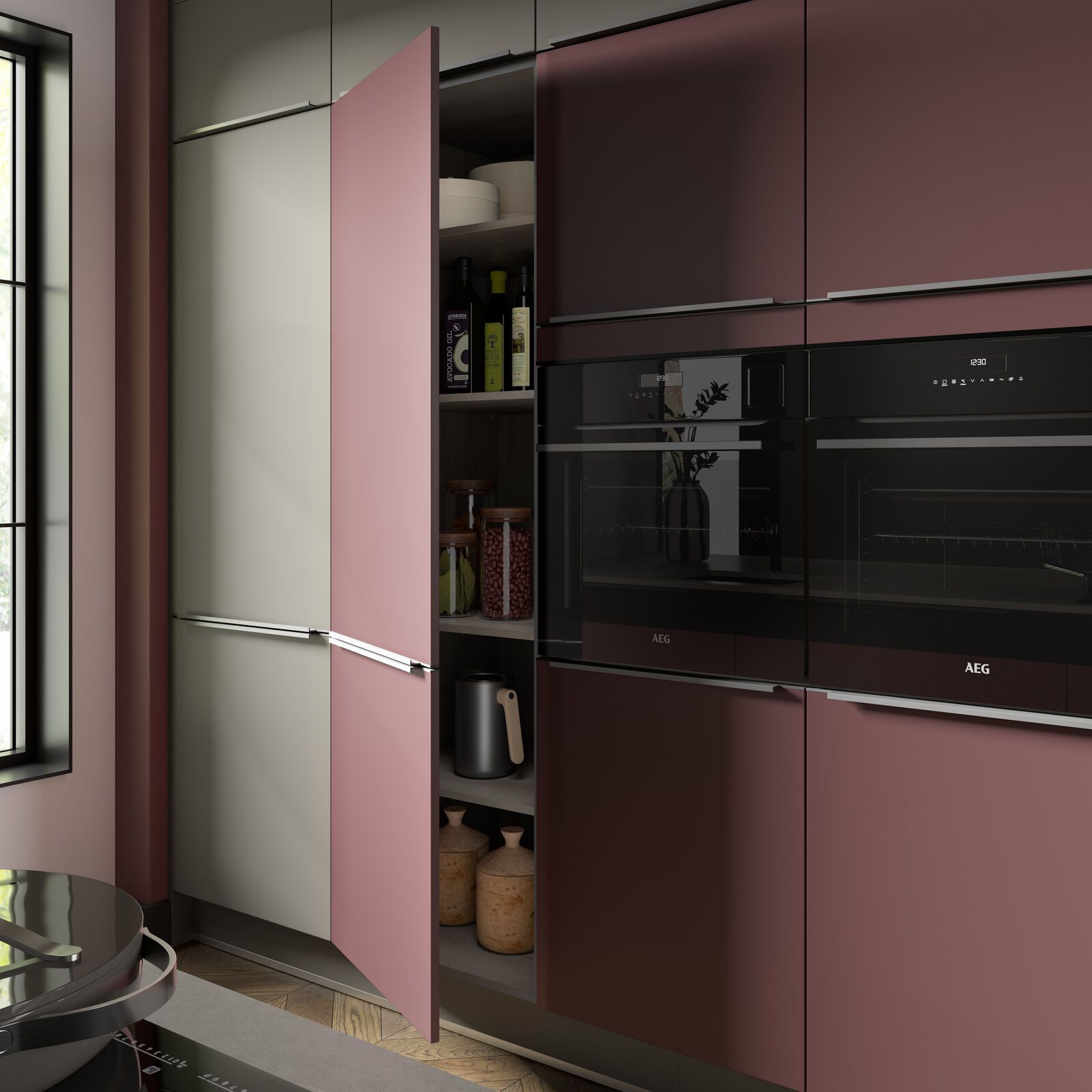 A kitchen with pink cabinets and a black oven