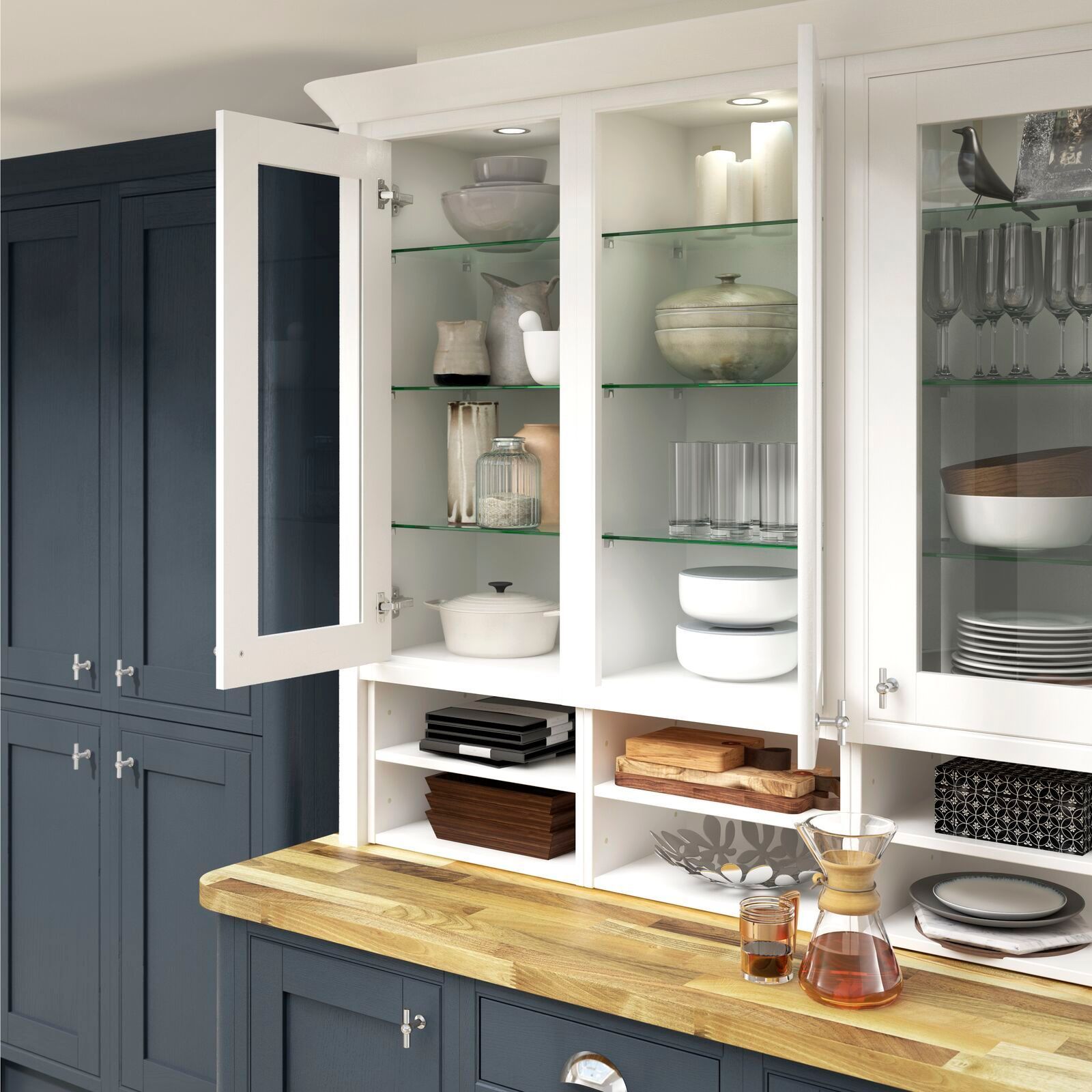 A kitchen with blue cabinets and white shelves with glass doors