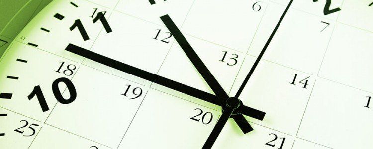 Close up of a clock face with calendar dates on the face.