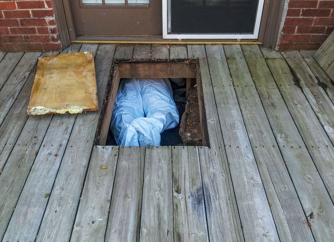 A wooden deck with a hole in the middle of it