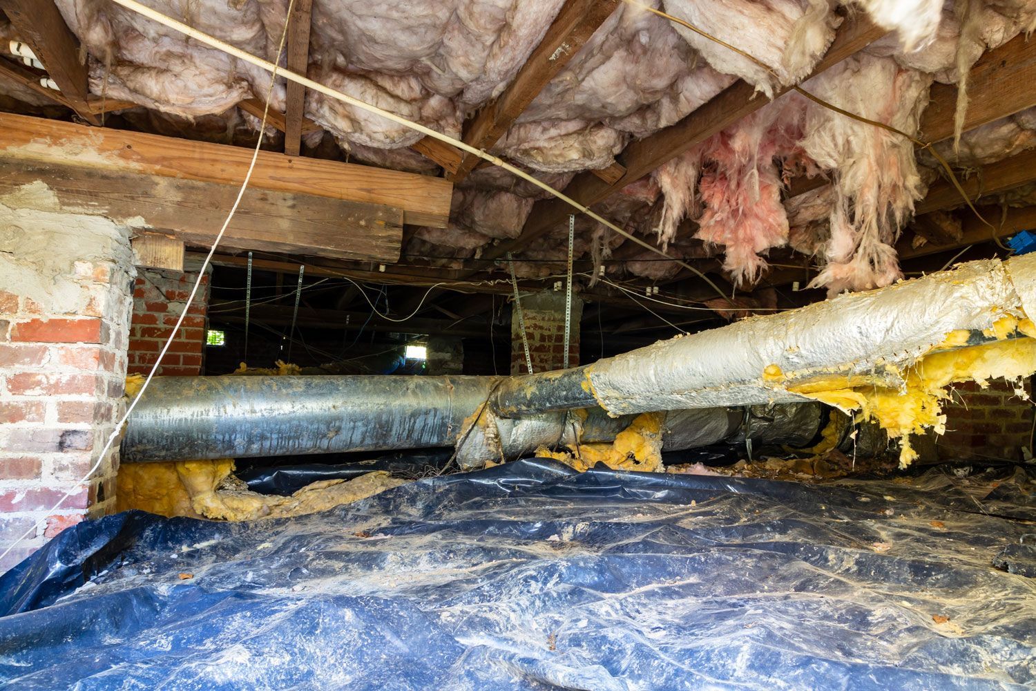 There is a lot of insulation in the attic of a house.