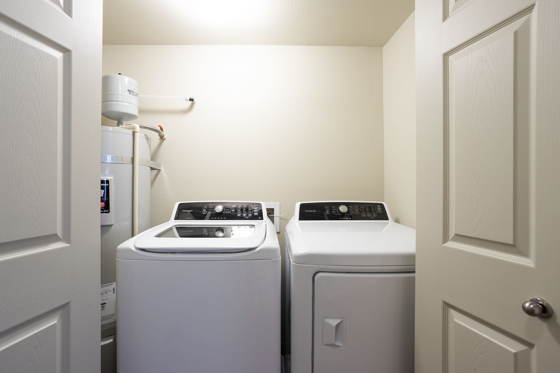 A laundry room with a washer and dryer in it.