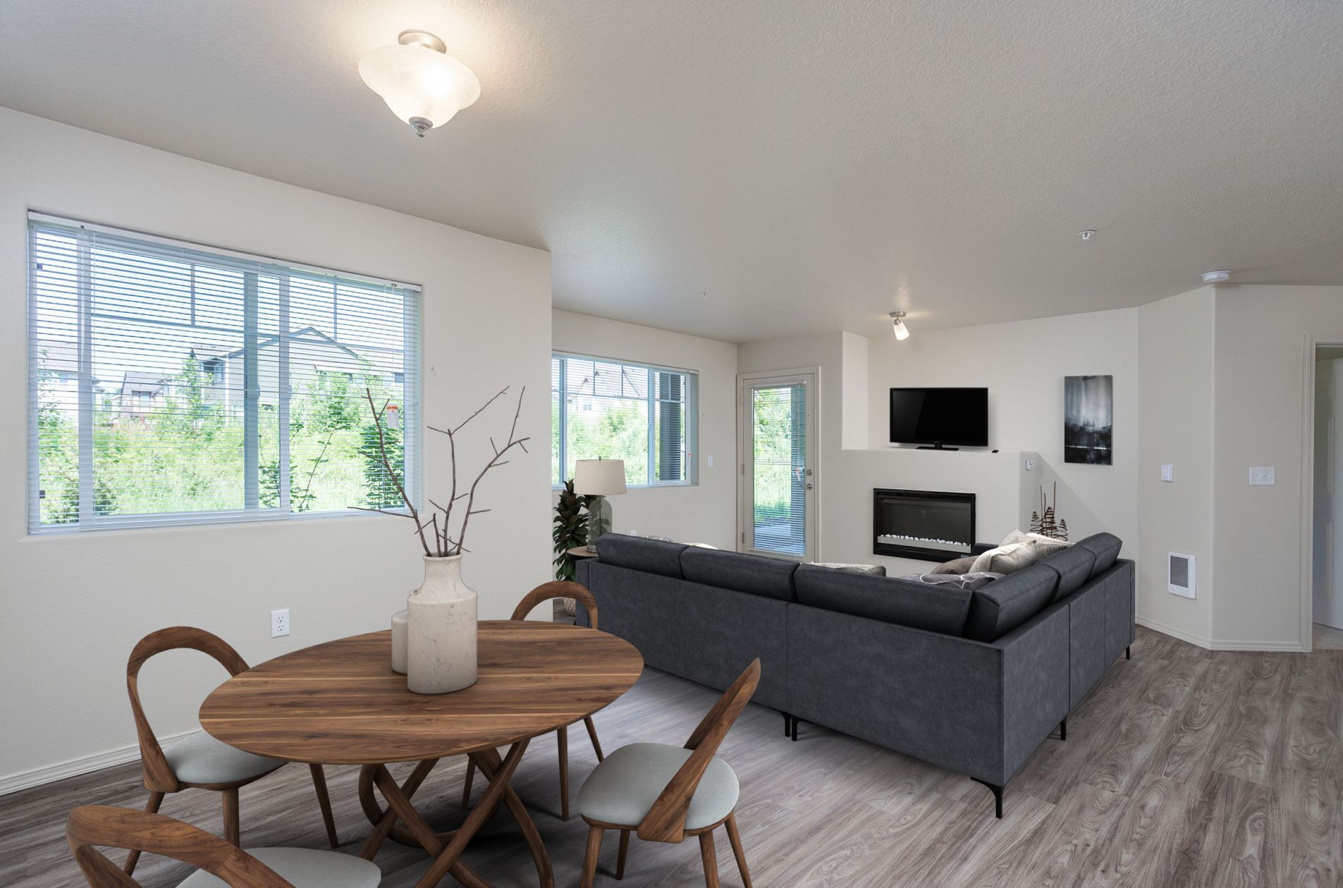 A living room with a couch , table , chairs and a fireplace.