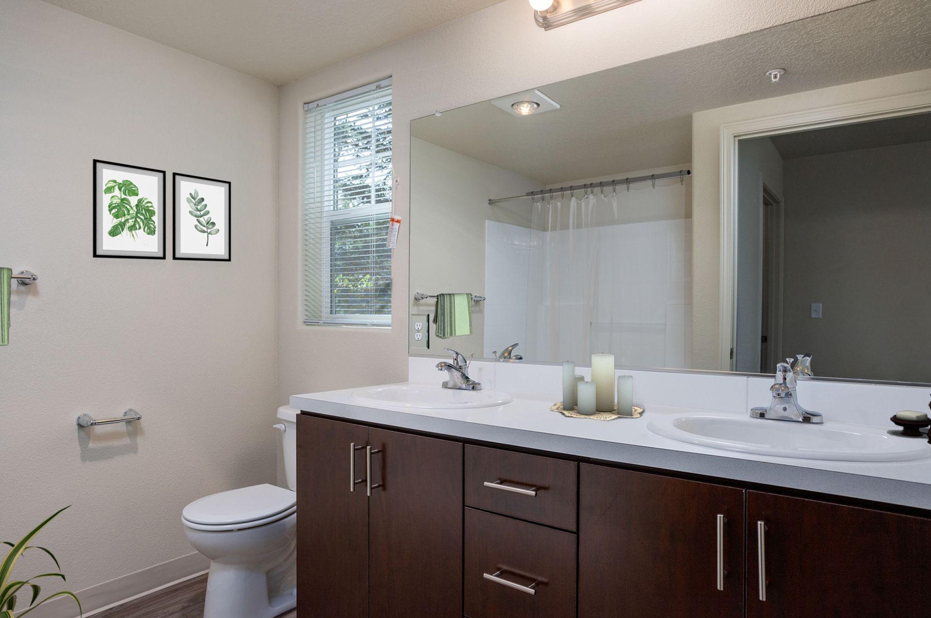 A bathroom with a toilet , sink and mirror