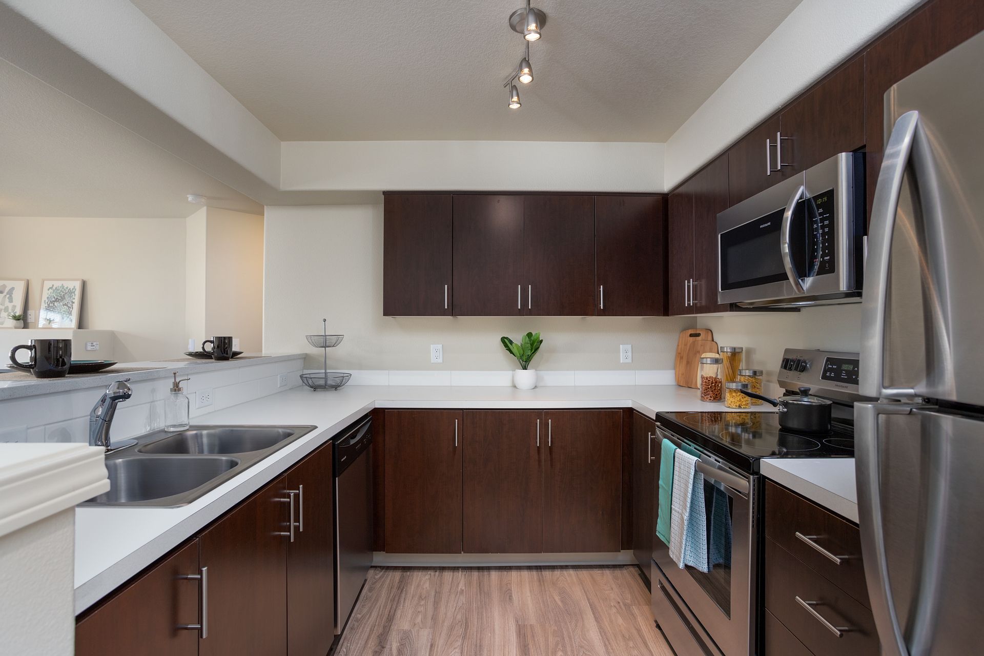A kitchen with stainless steel appliances and wooden cabinets