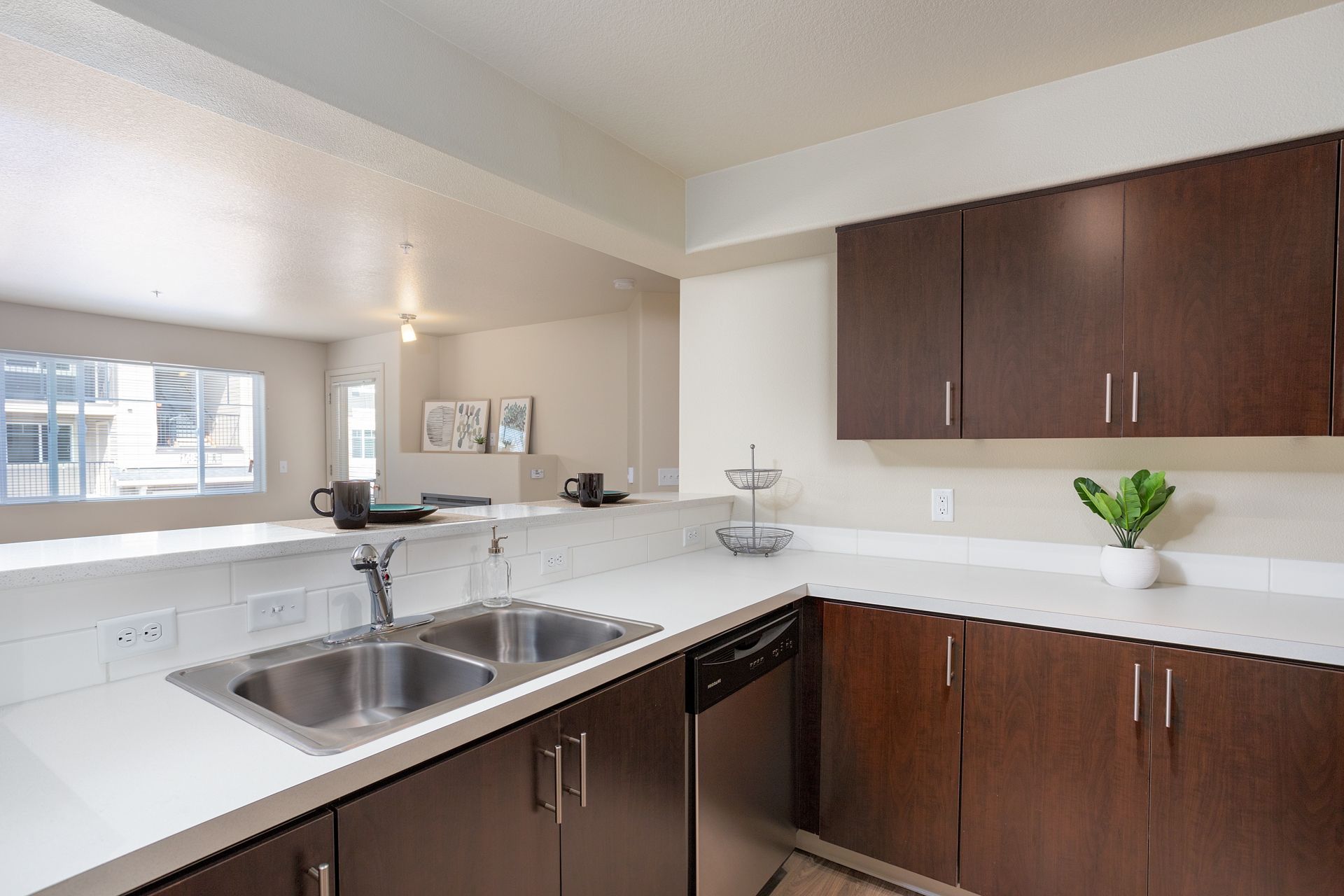 A kitchen with stainless steel appliances and wooden cabinets
