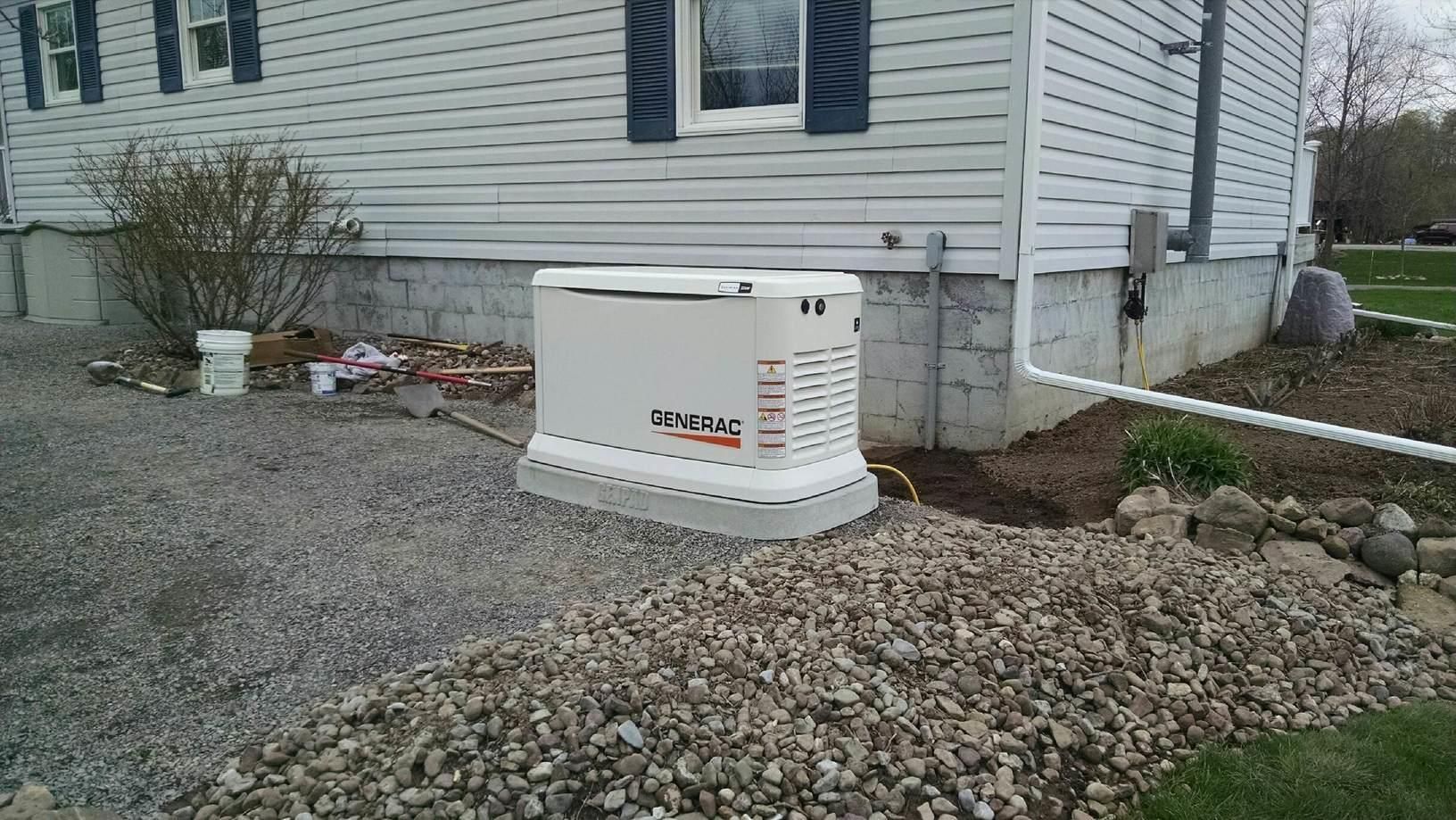 a generator is sitting on the side of a house .