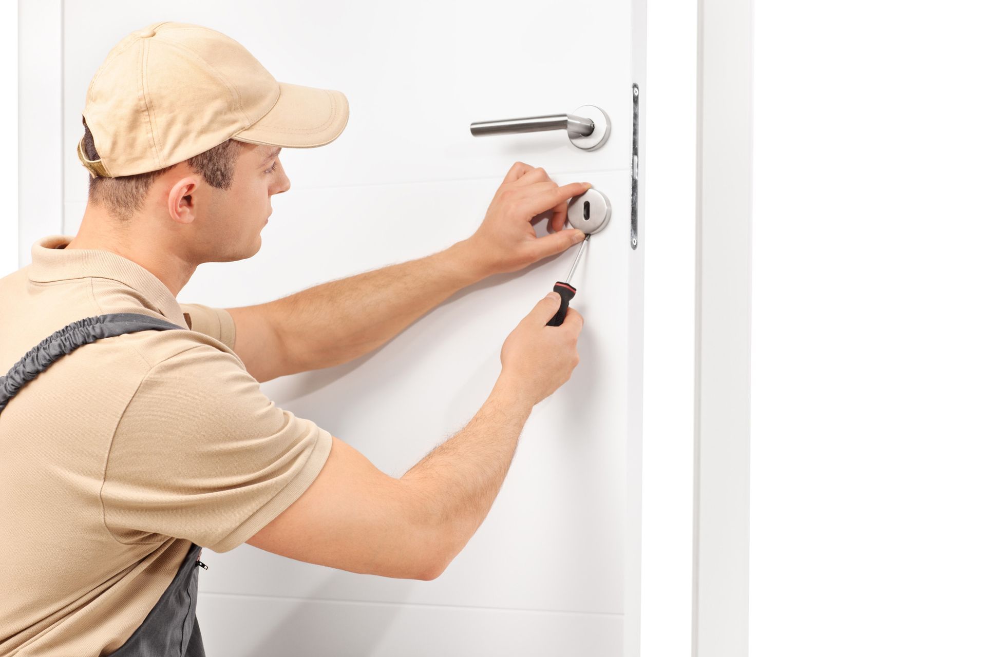 A man in a hat repairs a door handle, showcasing expertise as a 24-hour lock technician in Spanish S