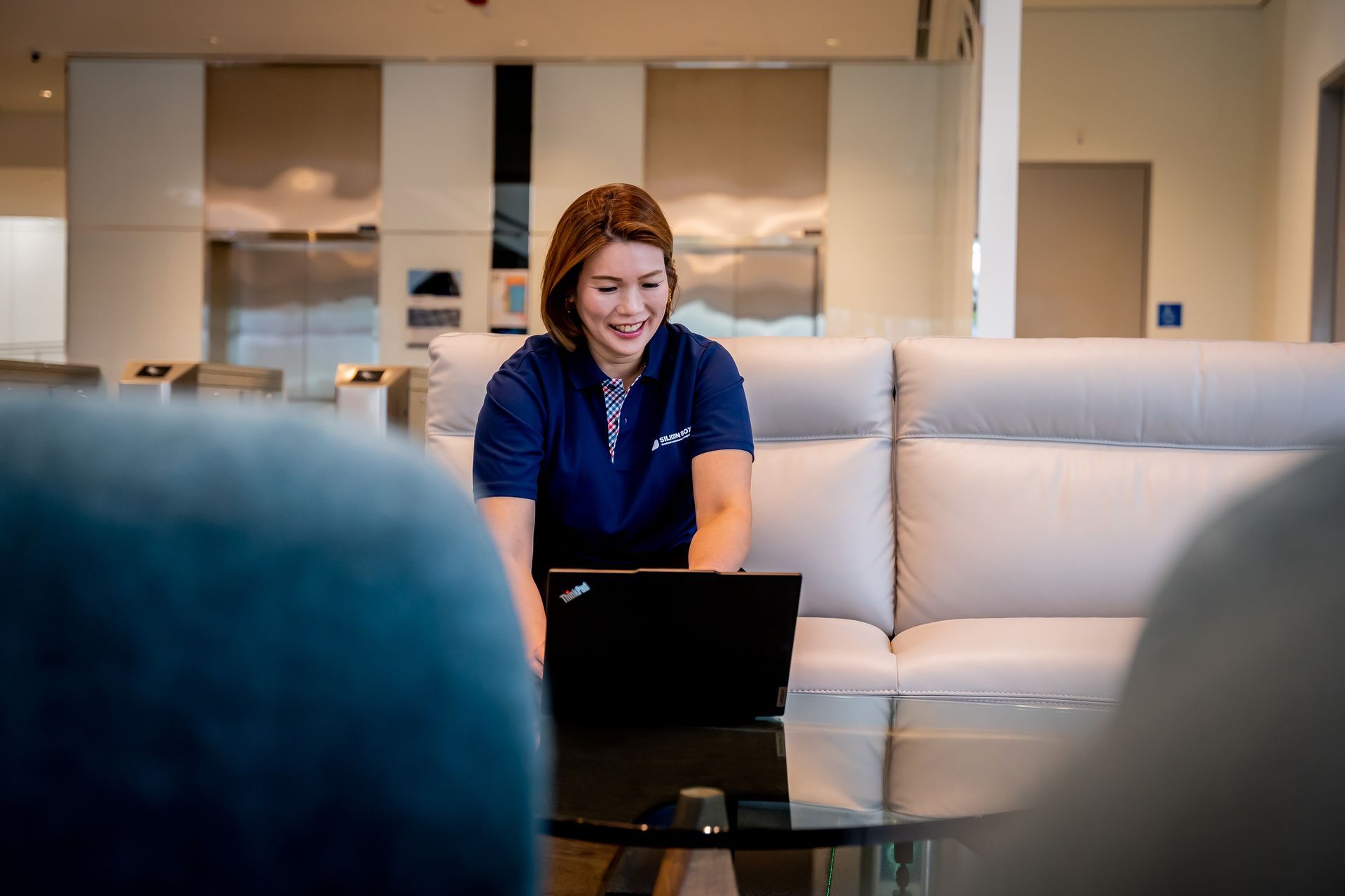 Hweeling, employee working in the lobby of Silicon Box HQ