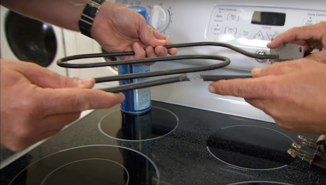 appliance technician repairing a stove top