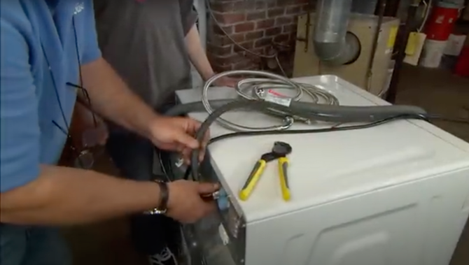 Appliance technician repairing a washing machine