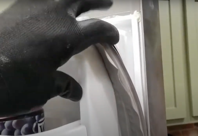 appliance technician repairing a refridgerator