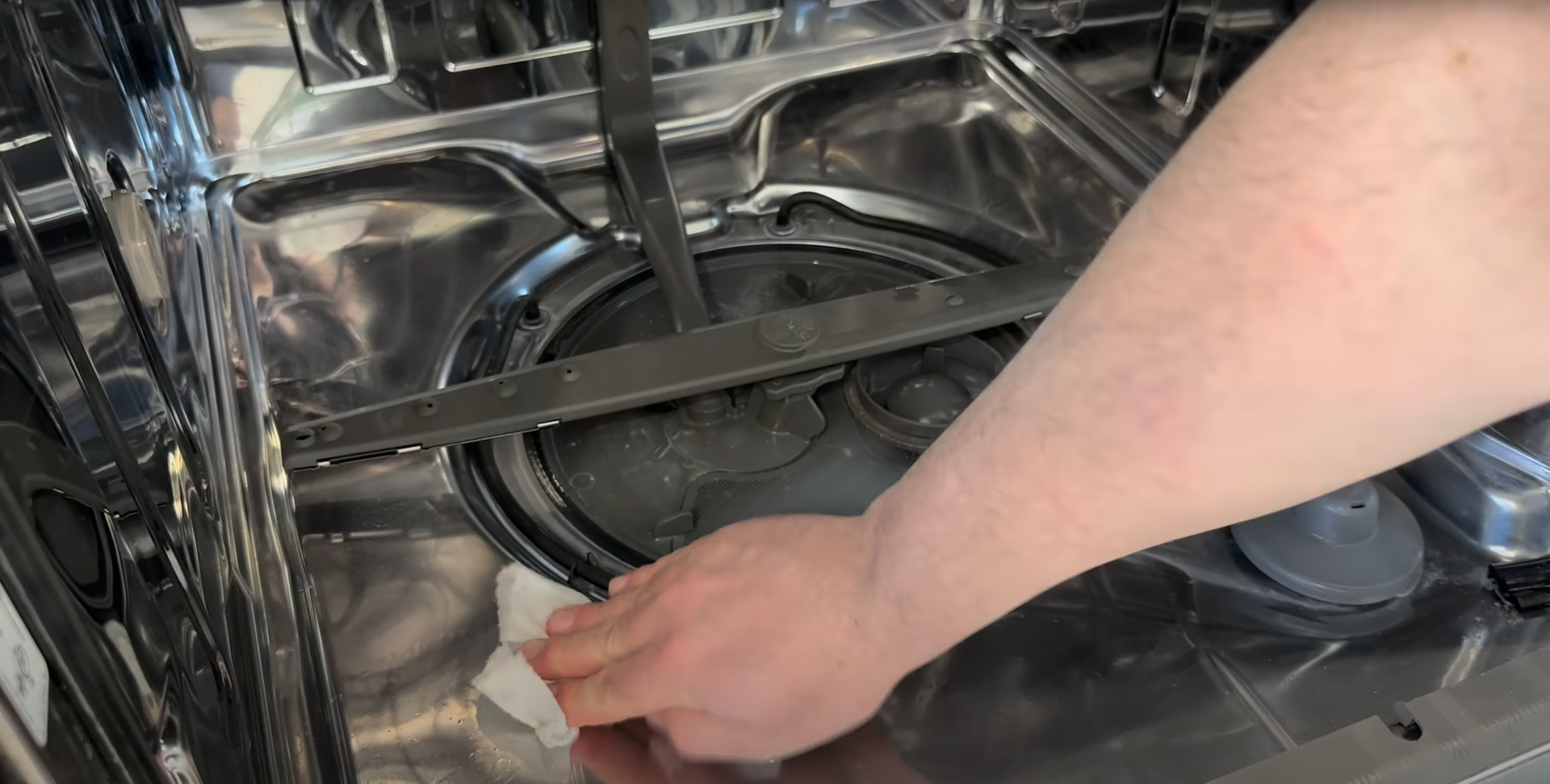technician repairing a dishwasher