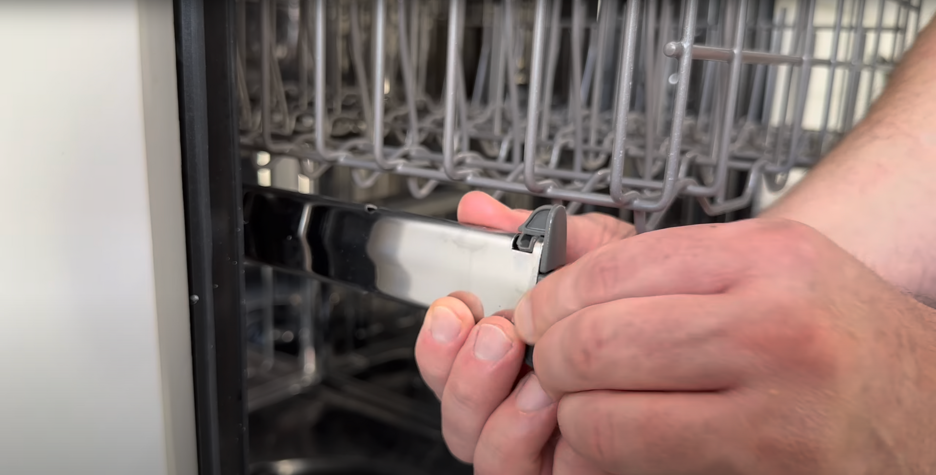 technician fixing dishwasher rack
