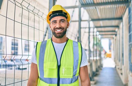 Happy construction worker in safety vest