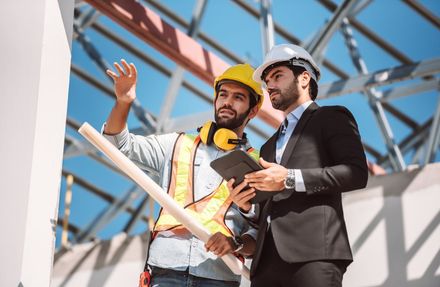 Manager meets with construction worker