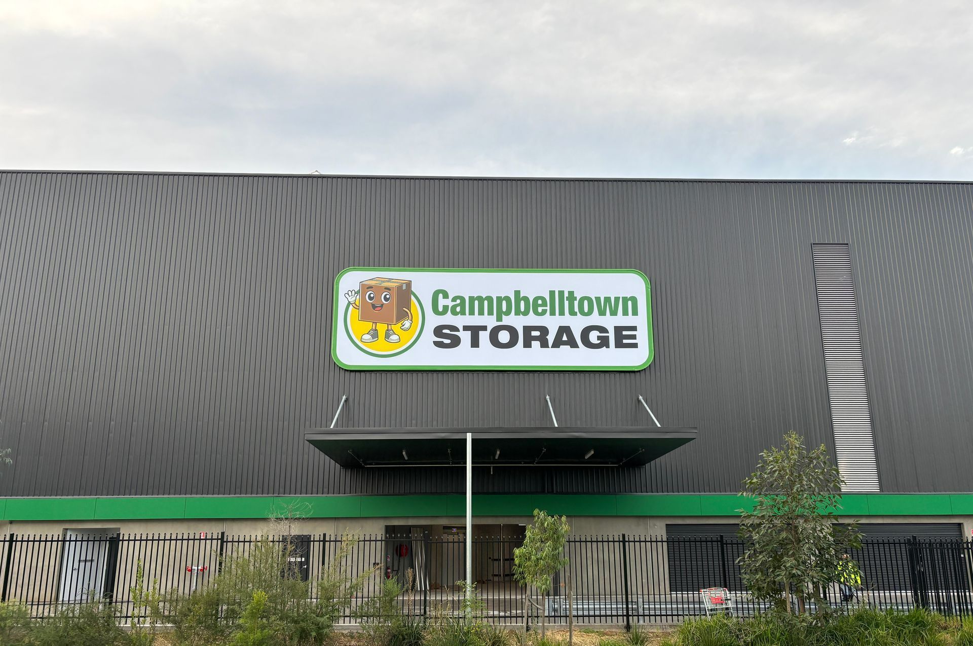 A large building under construction with a sign on the side of it.