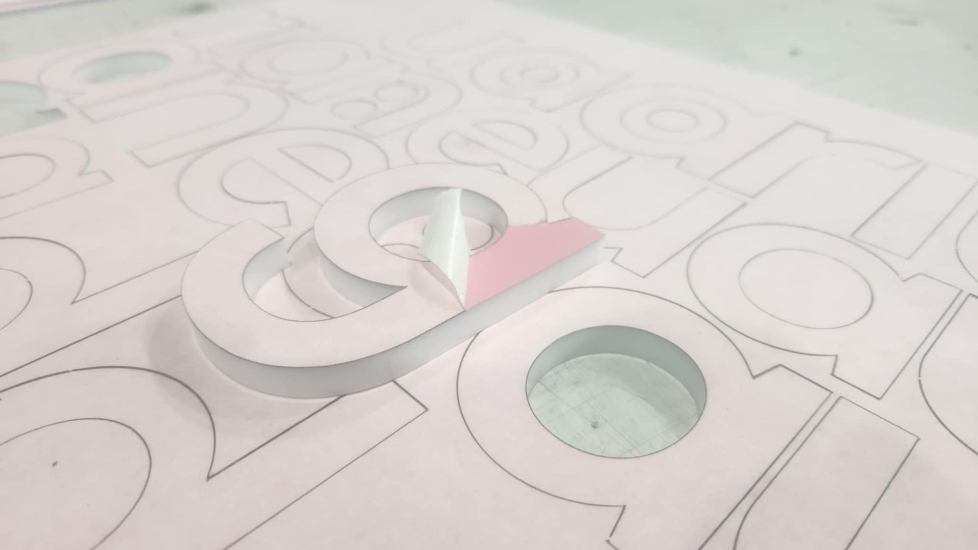 A close up of a piece of paper with letters cut out of it.