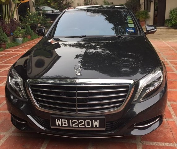 Black Mercedes-Benz sedan parked on a brick patio.  License plate reads WB 1220 W.