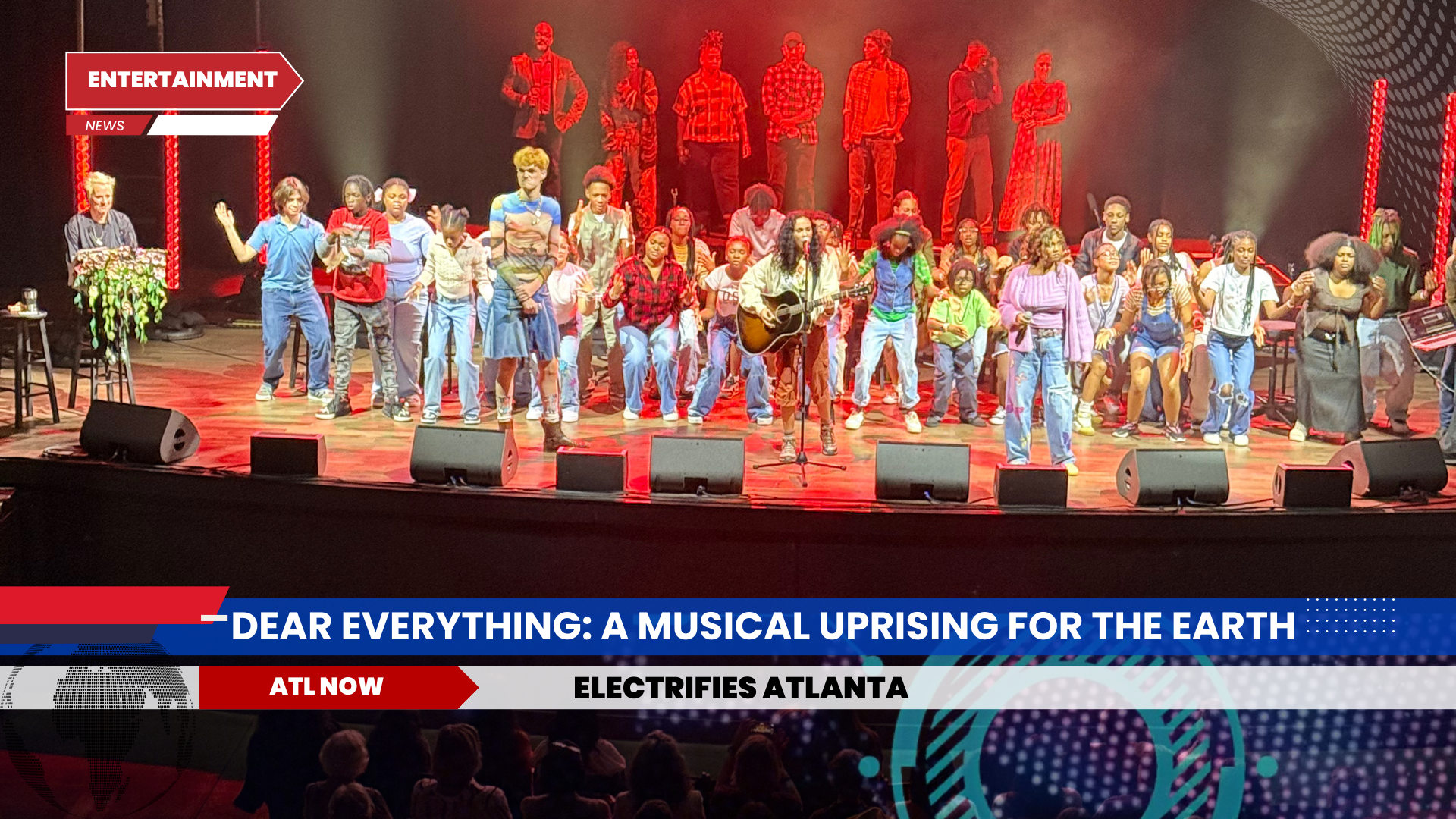 Large group of people on a stage with a band, red lights, and a musical title on a screen.