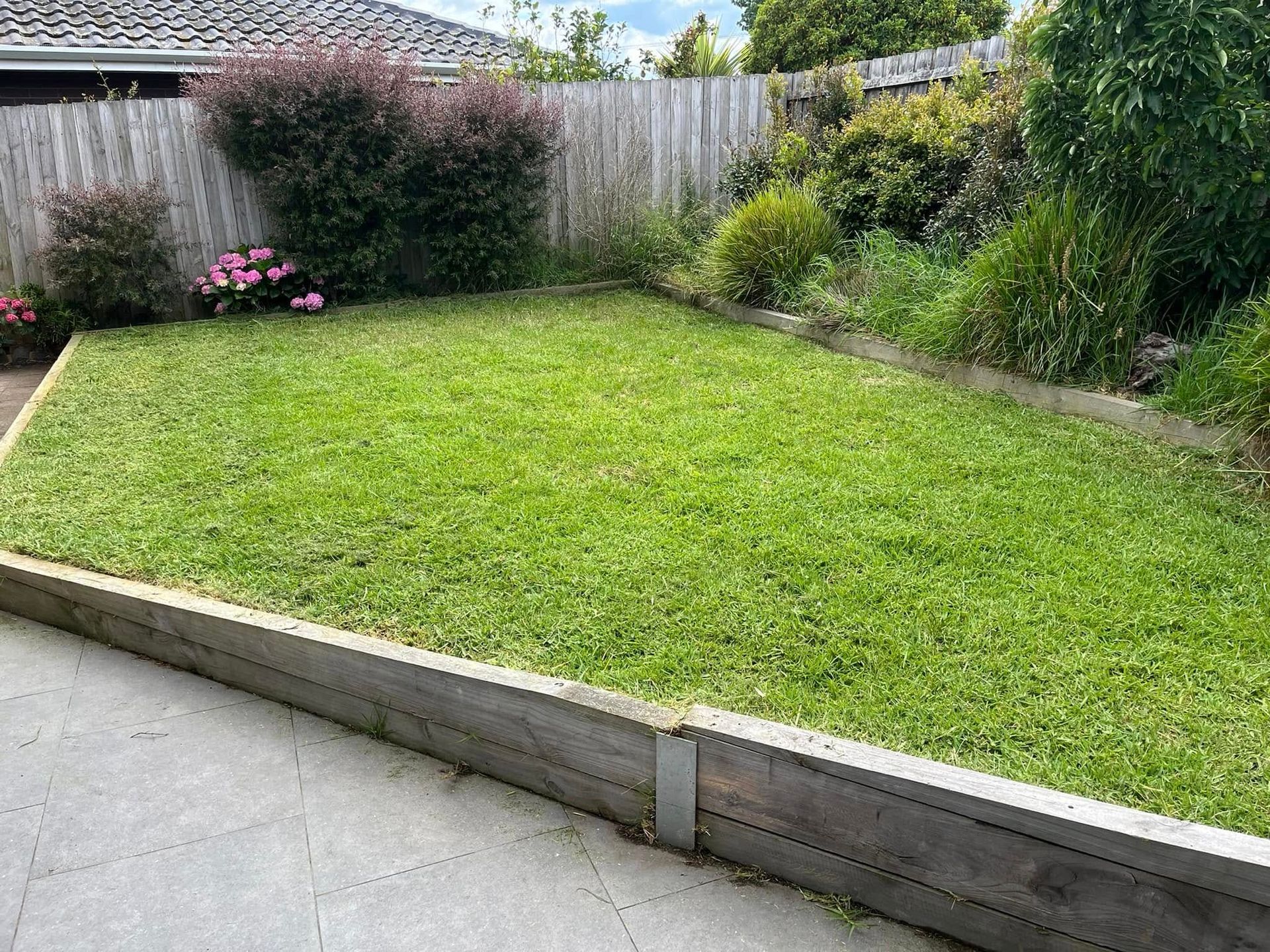 Wooden Fence Around A Green Lawn — RJT Lawn and Gardening in Drysdale, VIC