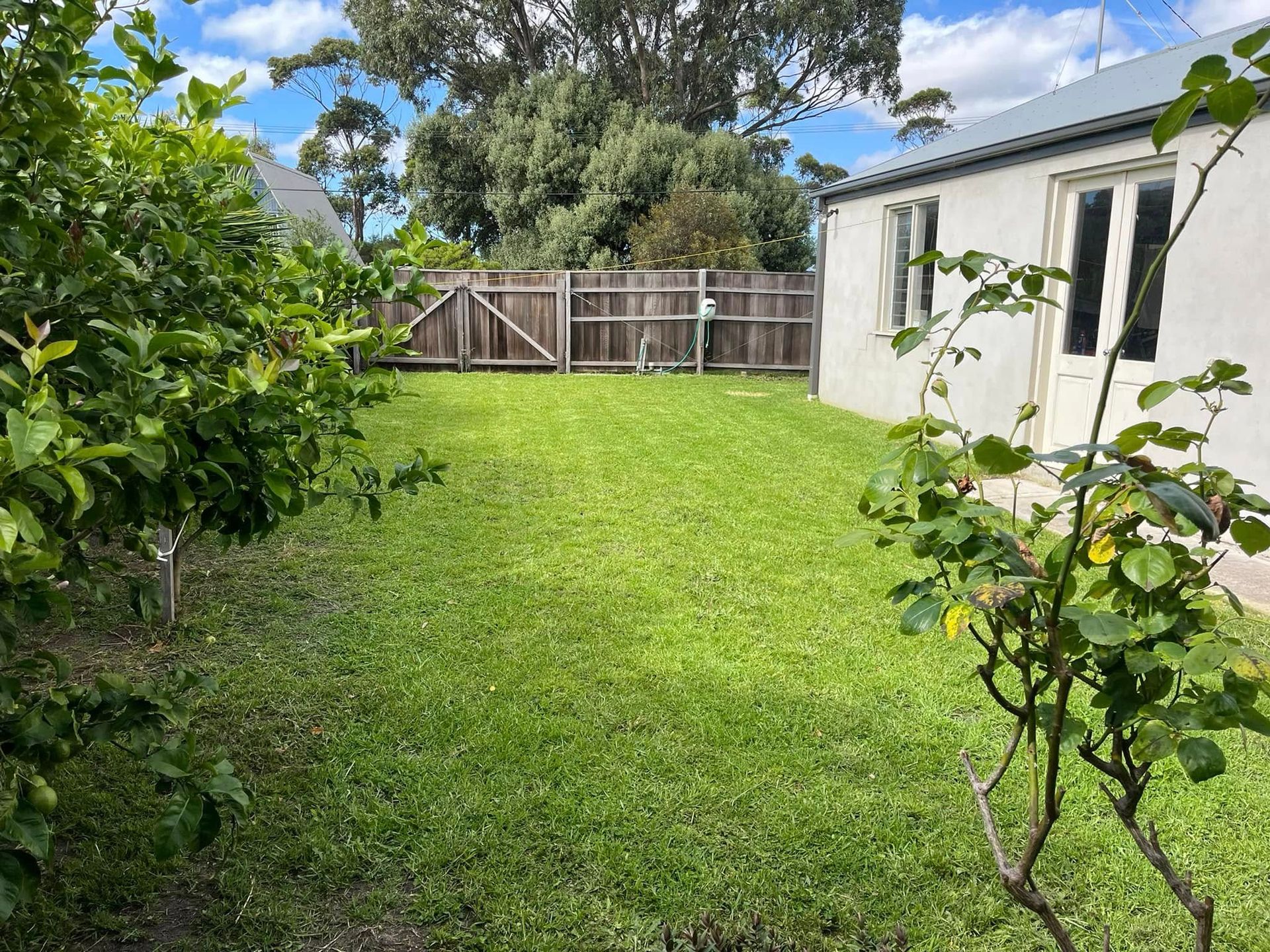 A Brick House With a Nice Garden — RJT Lawn and Gardening in Drysdale, VIC