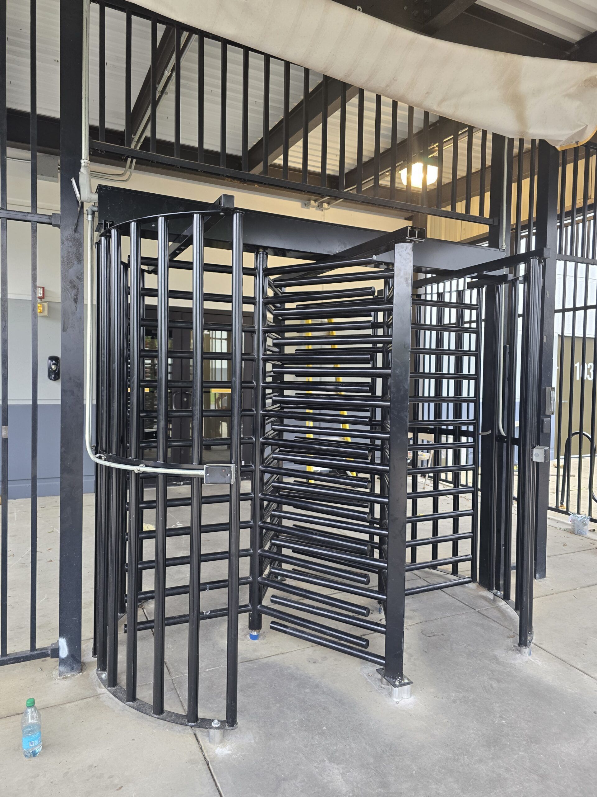 Black metal turnstile in an outdoor setting.