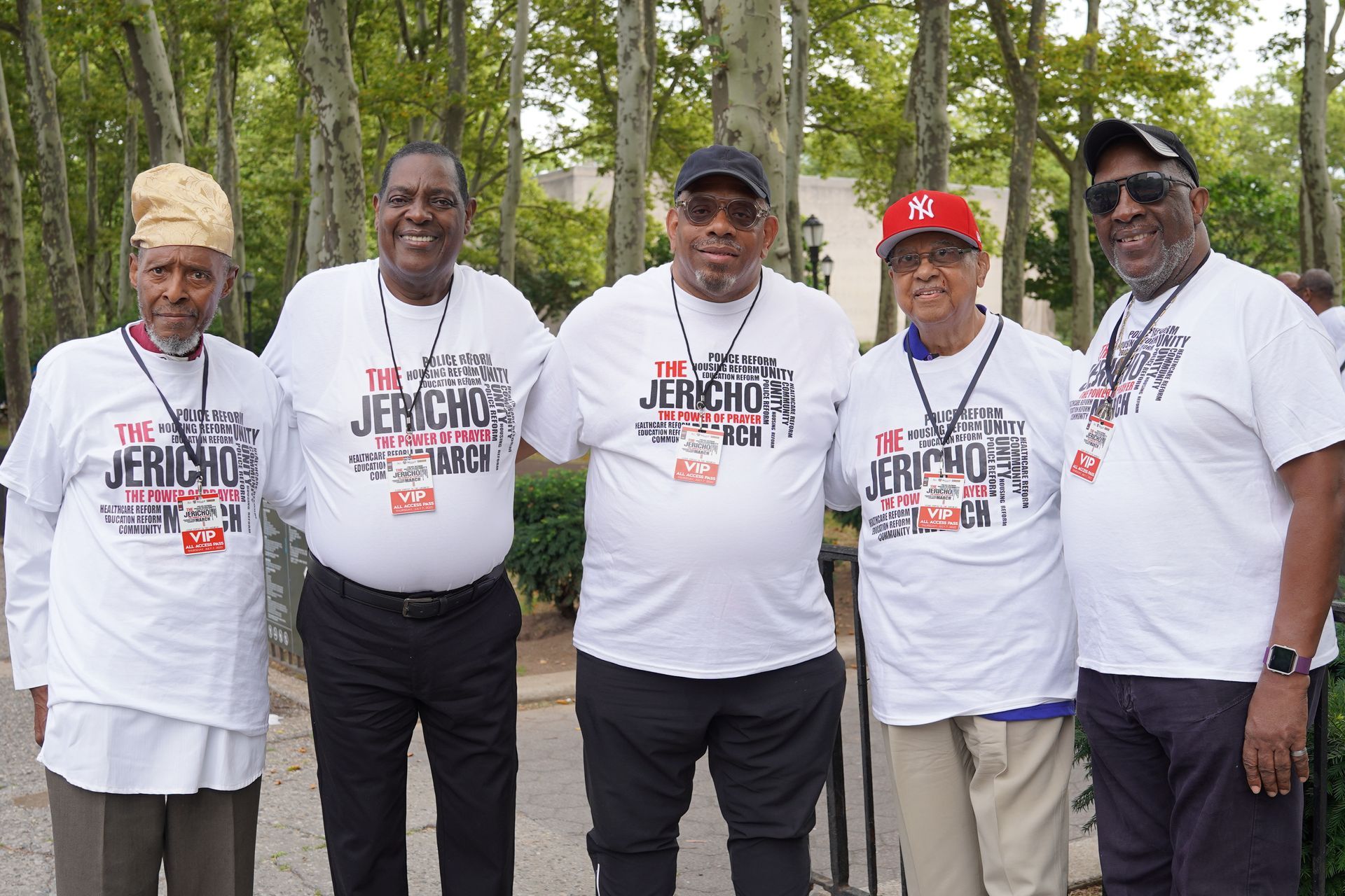 A group of men wearing jericho shirts pose for a picture