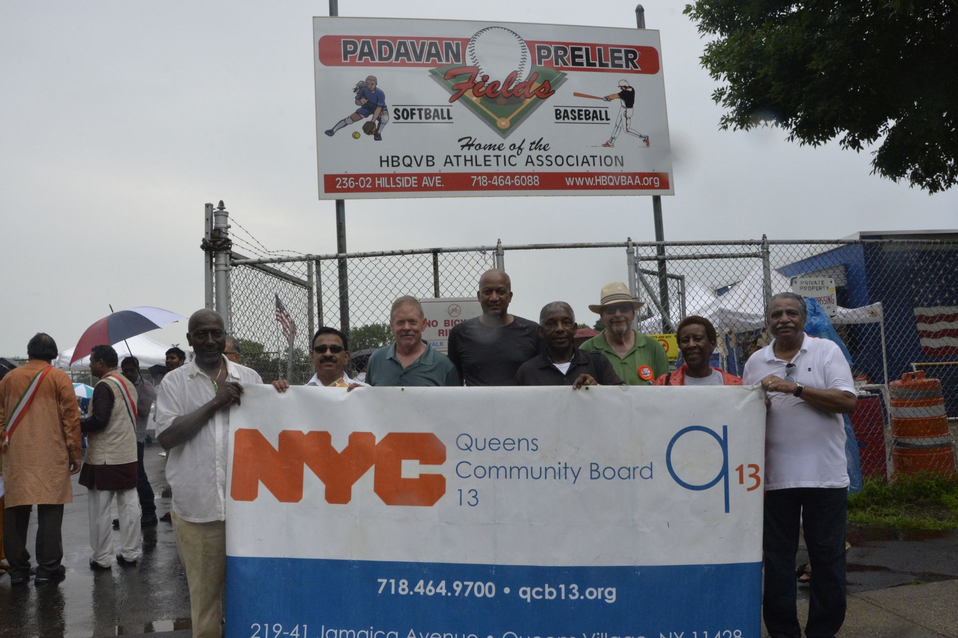 A group of people holding a nyc community board sign